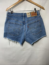 Levi's Women's 501 high rise distressed denim shorts in size 29, casual style, worn with frayed edges and light wash.