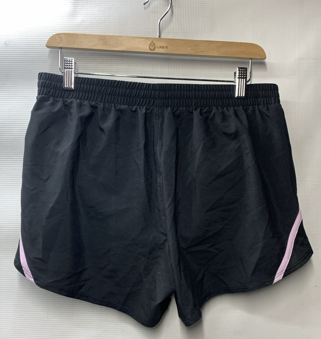 Black and lavender Under Armor Women's Fly By lined loose running shorts, size M, activewear shorts for women.