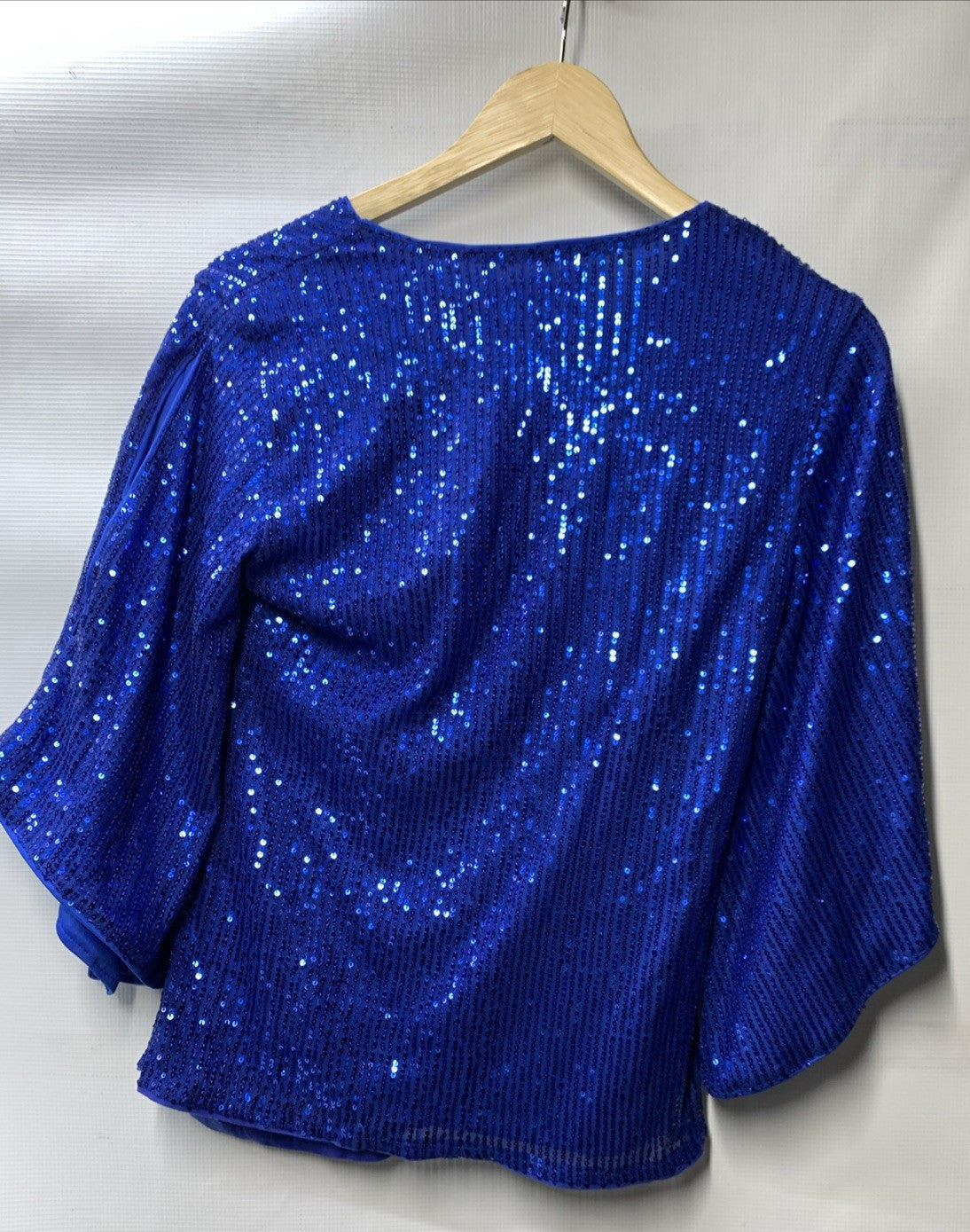Blue sequin women's top by The Family Flips with 3/4 sleeves, sparkly shimmer, and size S, styled for women’s clothing.