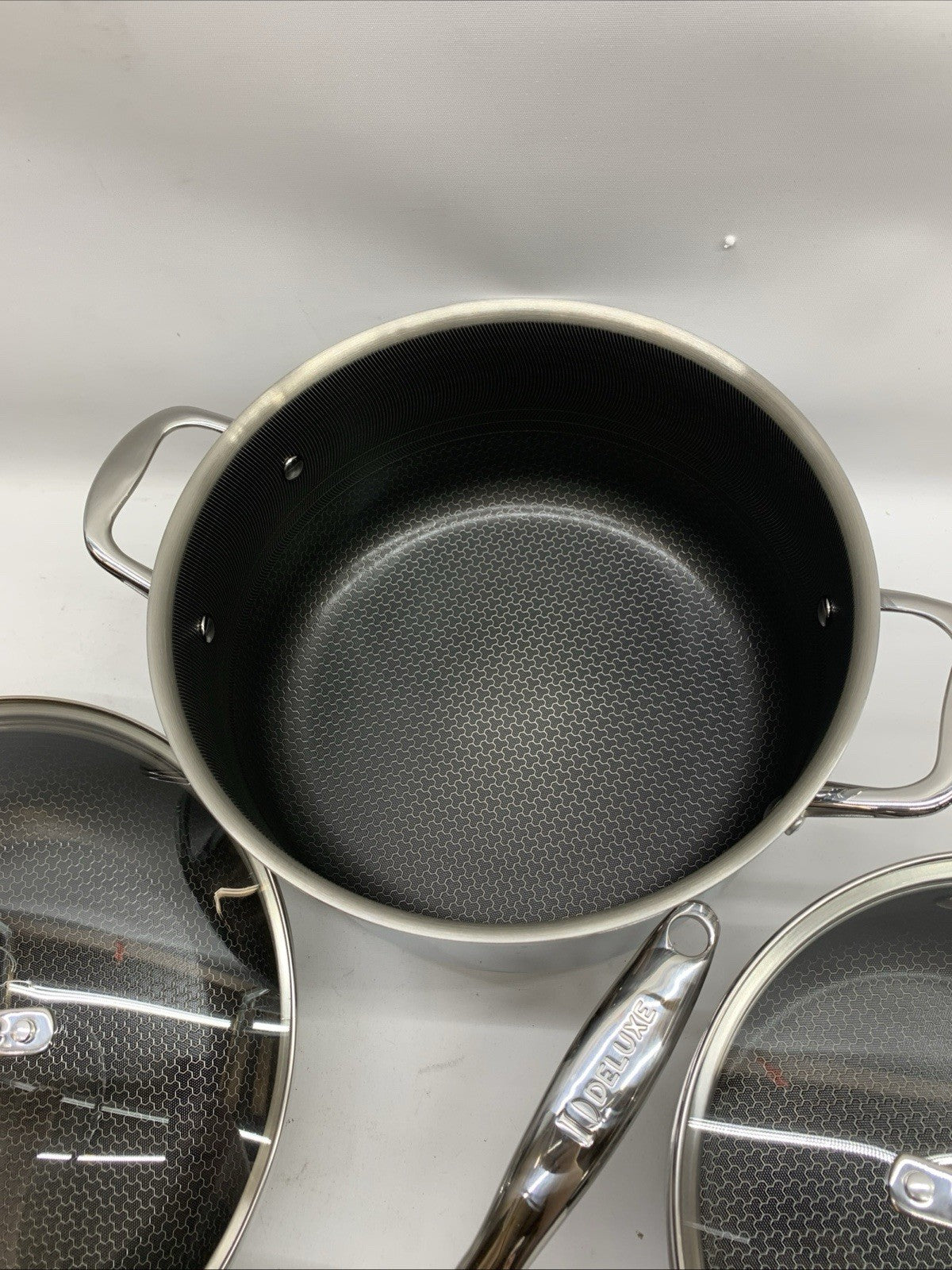 Deluxe 13-piece hybrid ceramic nonstick stainless steel cookware set by The Family Flips for versatile kitchen cooking.
