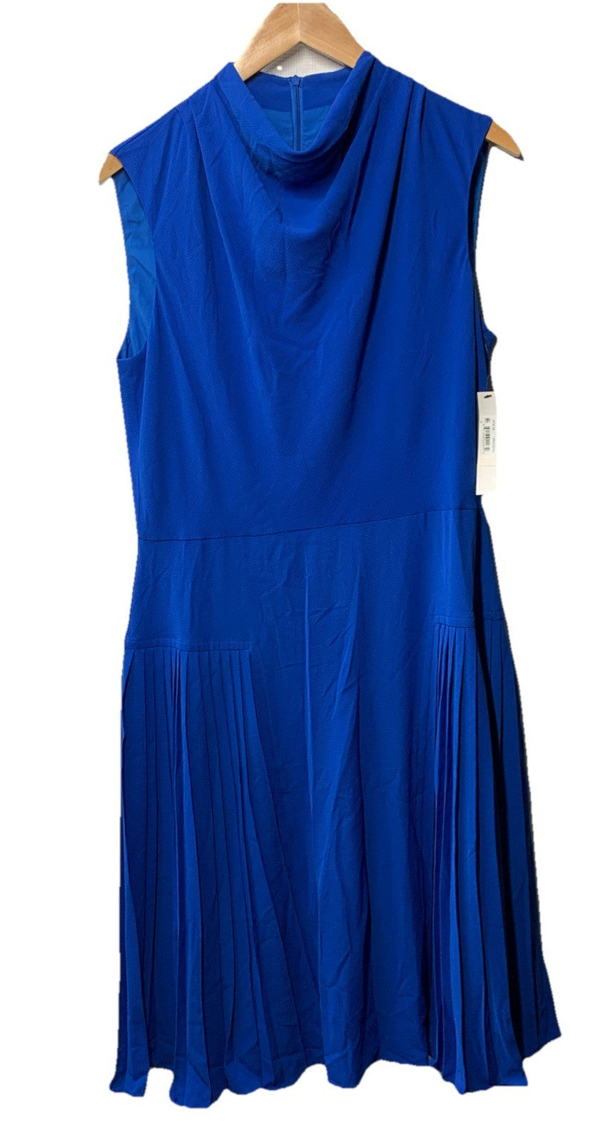 Black sleeveless Maggy London cowl neck dress with fluted skirt, size 14, from The Family Flips, shown on a hanger.