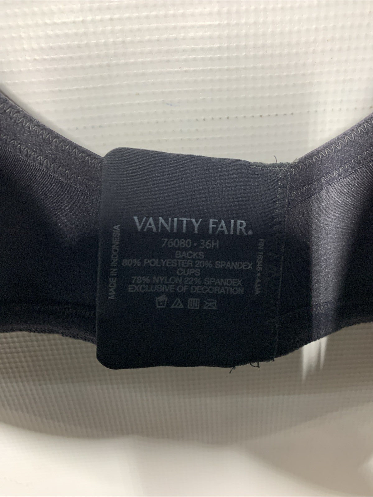Black Vanity Fair women's minimizer underwire bra in size 36H, featuring smoothing cups and adjustable straps.