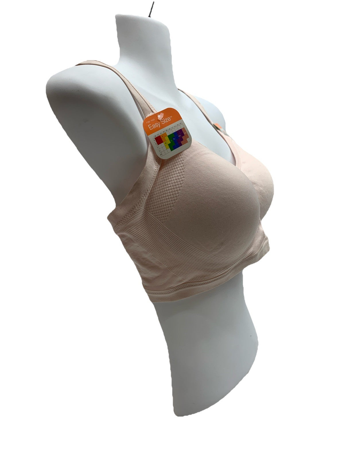 Light beige Warners women's wireless bra with seamless design and light lining, from The Family Flips, displayed flat with smooth fabric.