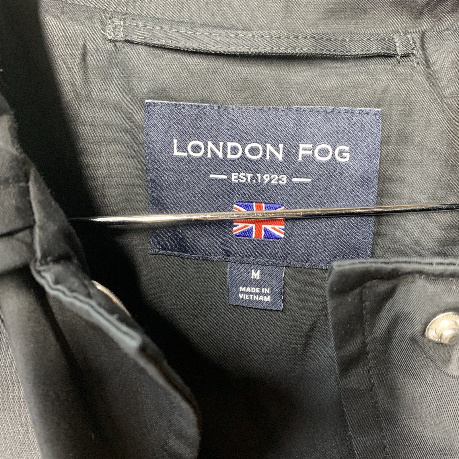 London Fog women's black trench coat with hood, long sleeves, and pockets, featuring a classic tailored design.