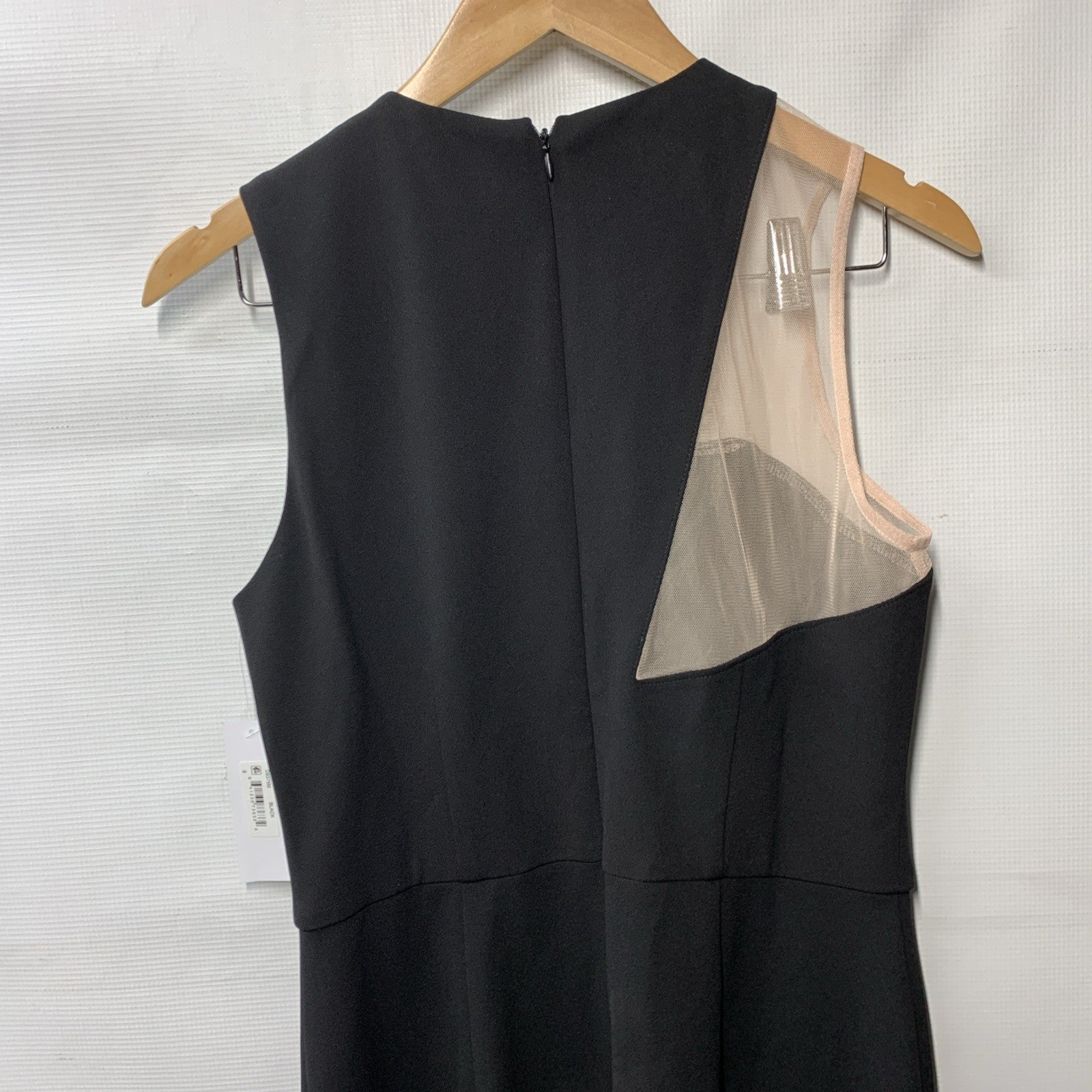 Black Donna Morgan sleeveless evening dress with asymmetrical cutout and high slit, size 8, styled for elegant occasions.