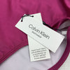Calvin Klein women's fuchsia shimmer convertible swim bottom swimsuit in size small, shown on a model.