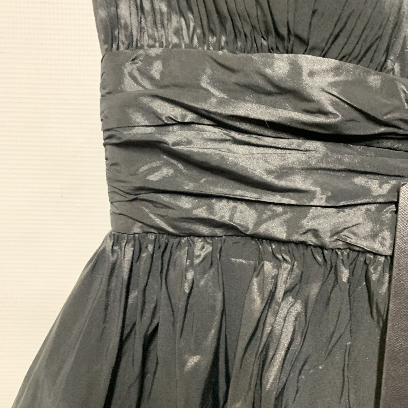 Black BCBGMAXAZRIA women’s mini strapless ruched evening dress in size 6, shown on a hanger with a fitted silhouette.