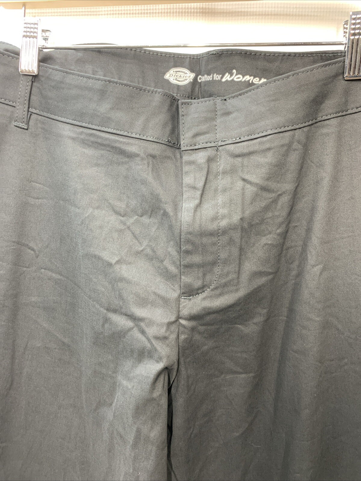 Dickies women's flat front stretch twill long pants in desert black, size 24, regular fit, shown on a model.
