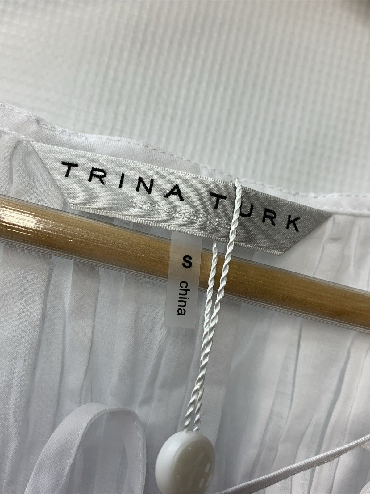 White sleeveless Trina Turk Soraveta top for women, size small with string tie detail, stylish casual clothing.