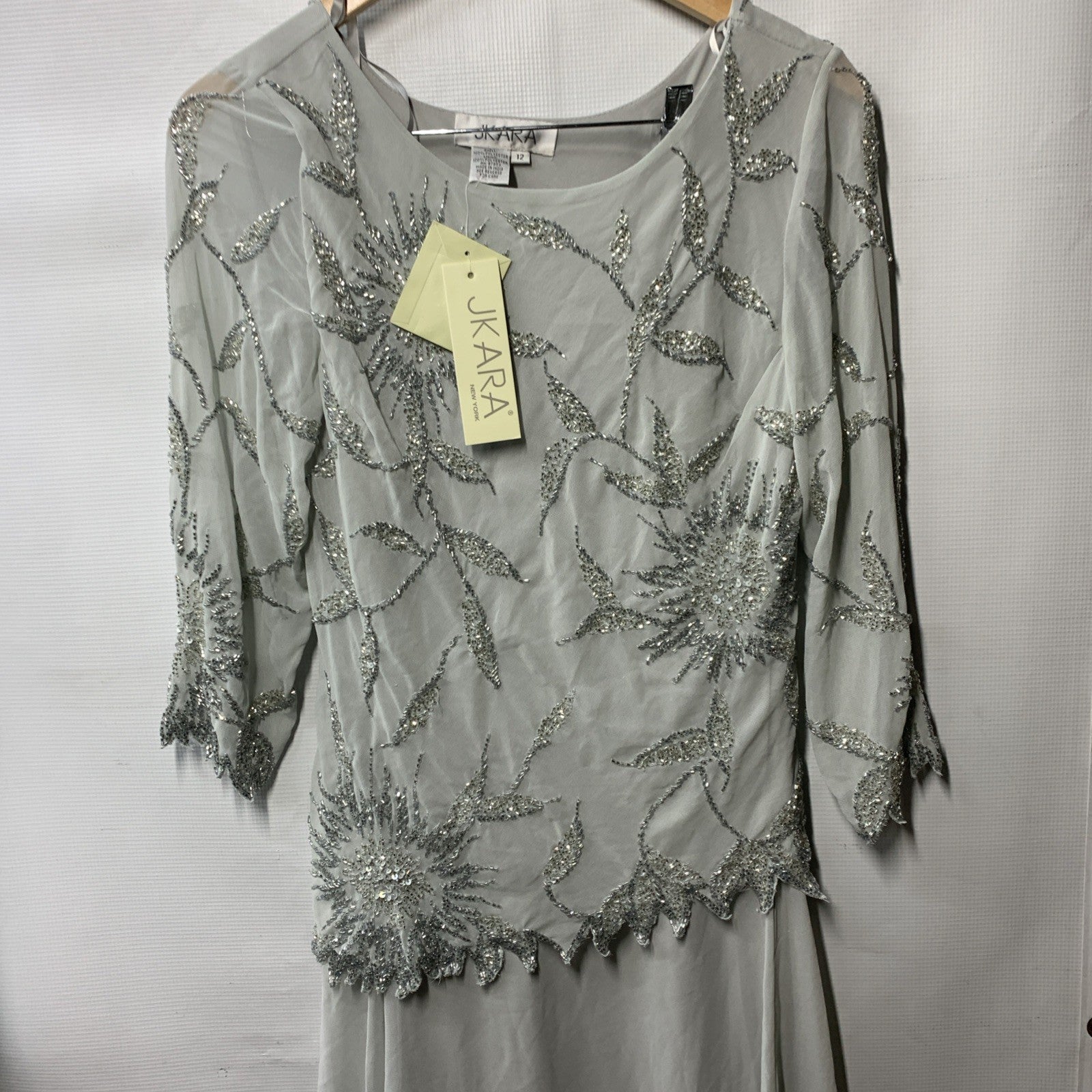 Gray beaded long evening dress for women with scoop neck and 3/4 sleeves, size 12, from J Kara, featuring elegant details.