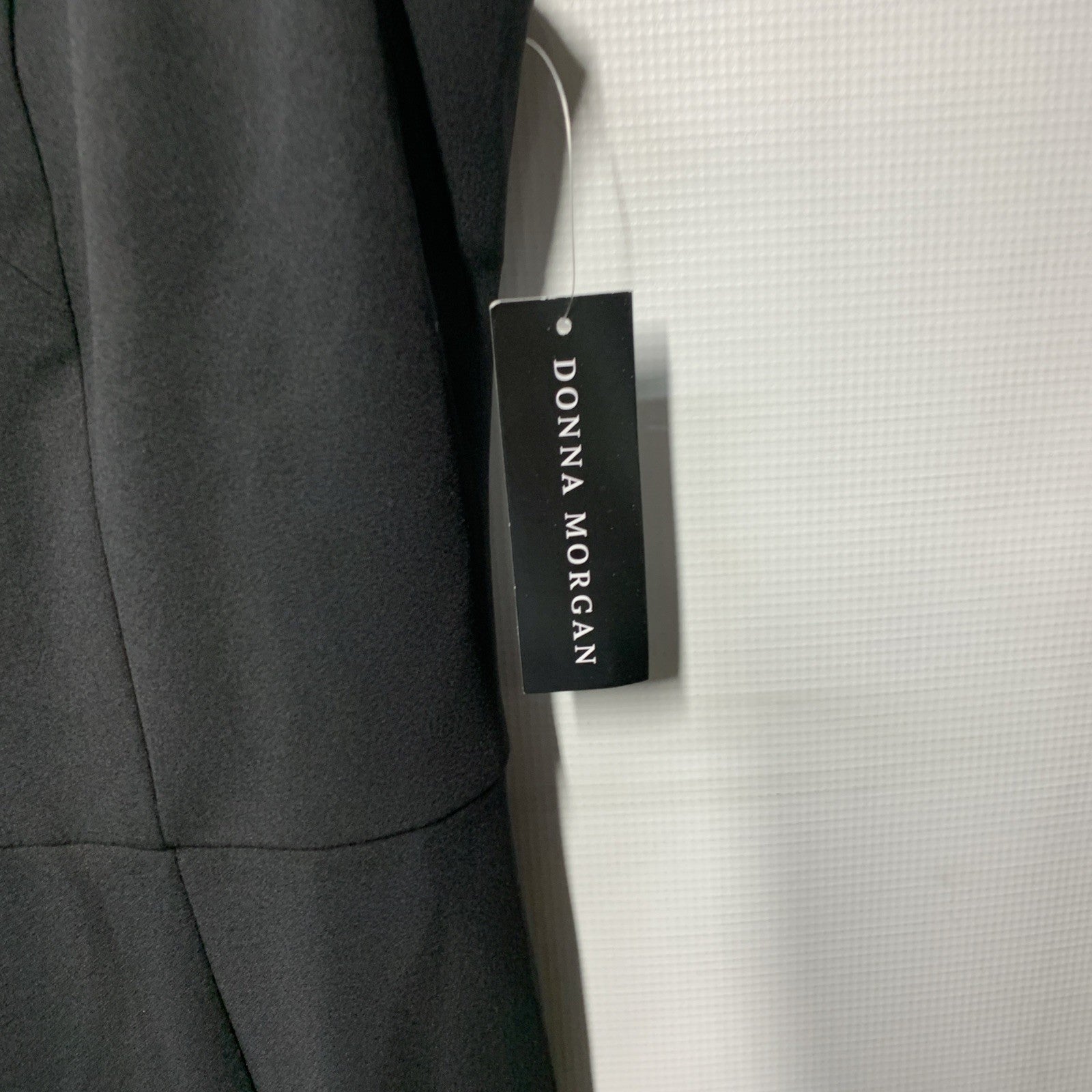 Black Donna Morgan sleeveless evening dress with asymmetrical cutout and high slit, size 8, showcasing elegant design and fit.