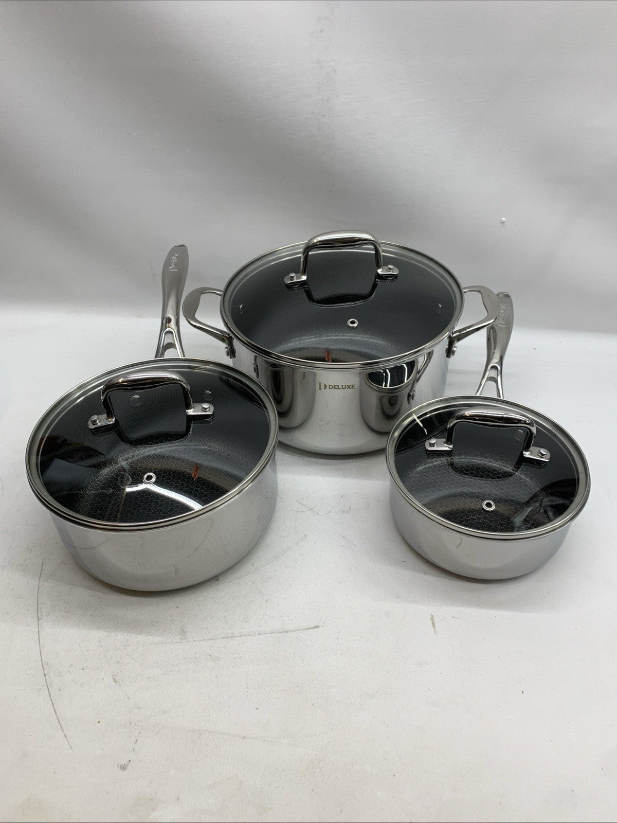 Deluxe 13-piece hybrid ceramic nonstick stainless steel cookware set by The Family Flips, including various pots and pans for versatile cooking.