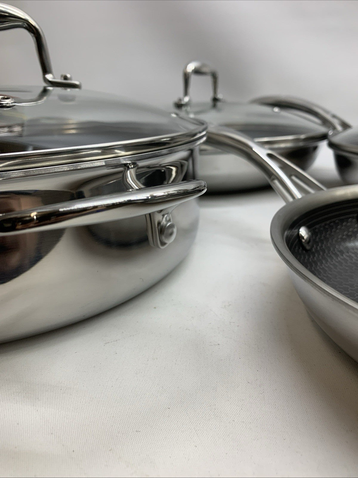 Family Flips Deluxe 13-piece hybrid ceramic nonstick stainless steel cookware set with various pots and pans for kitchen cooking.