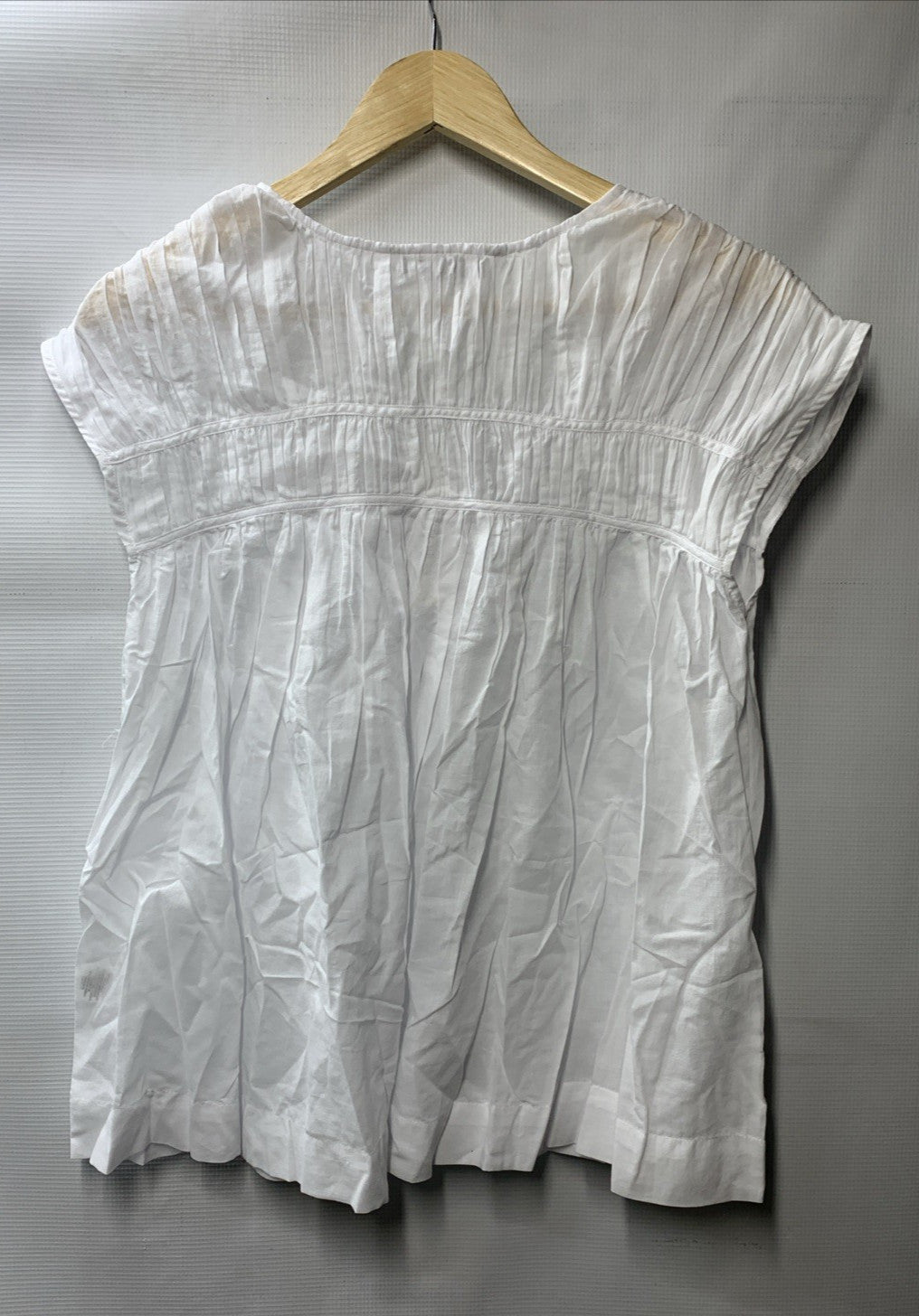 White sleeveless Soraveta top for women by Trina Turk, size small, with string tie detail.