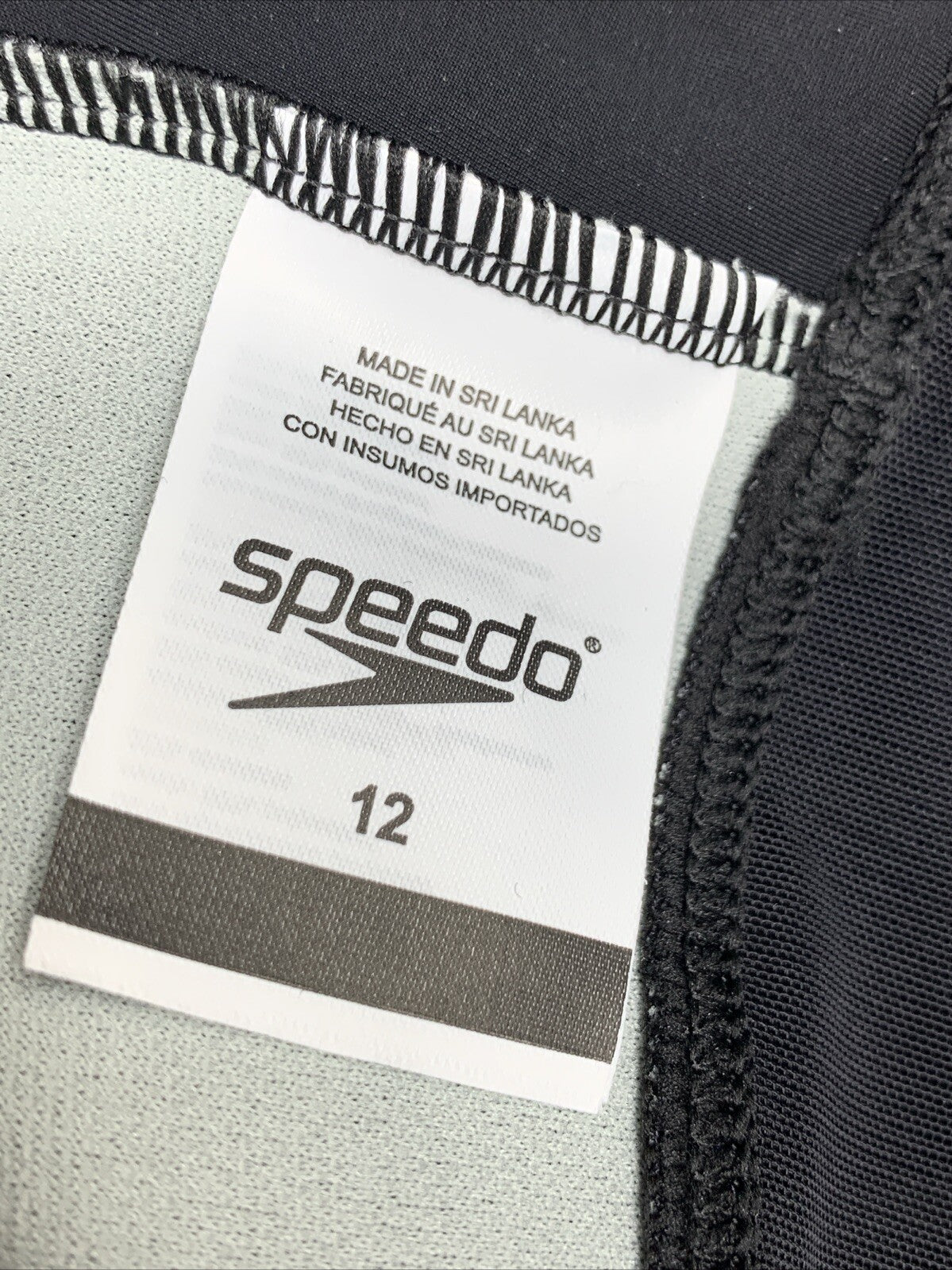 Black Speedo women's one-piece swimsuit with high neck and contemporary cut, size 12, ideal for swimming and water activities.