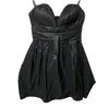 Black BCBGMAXAZRIA strapless mini dress with ruched details, perfect for evening wear, size 6, styled on a hanger.